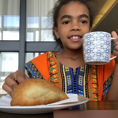 Angel enjoying her breakfast on Kiswahili Day.jpg