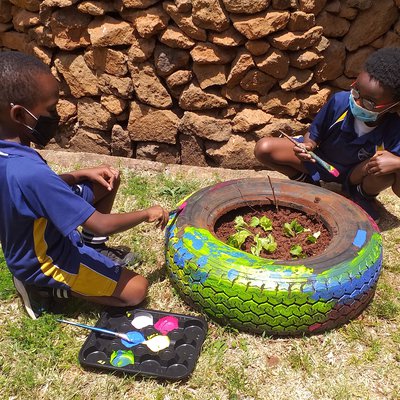 Austin and Ntongai painting the adopted tyre..jpg